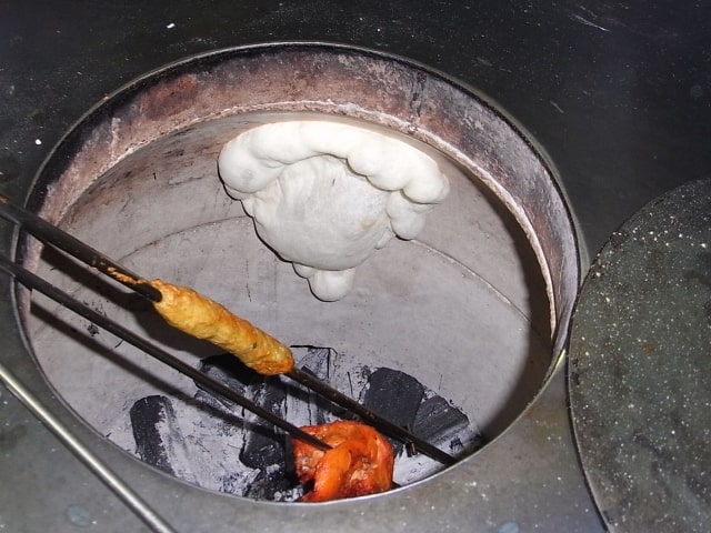 タンドール釜で焼いているナンとタンドリーチキン